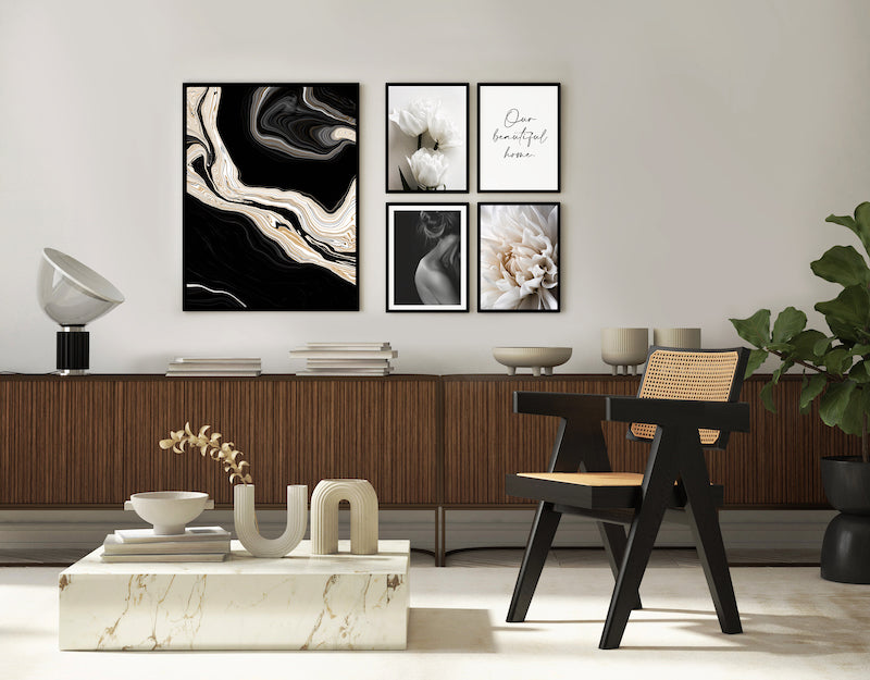 Black and white gallery wall with botanical wall art, abstract and photography pictured in a neutral living room.