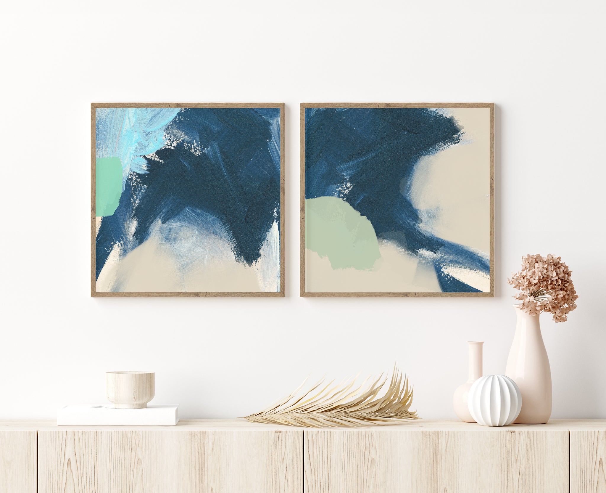 Set of 2 blue, green and neutral abstract wall art reflective of the beach and framed in wooden frames.