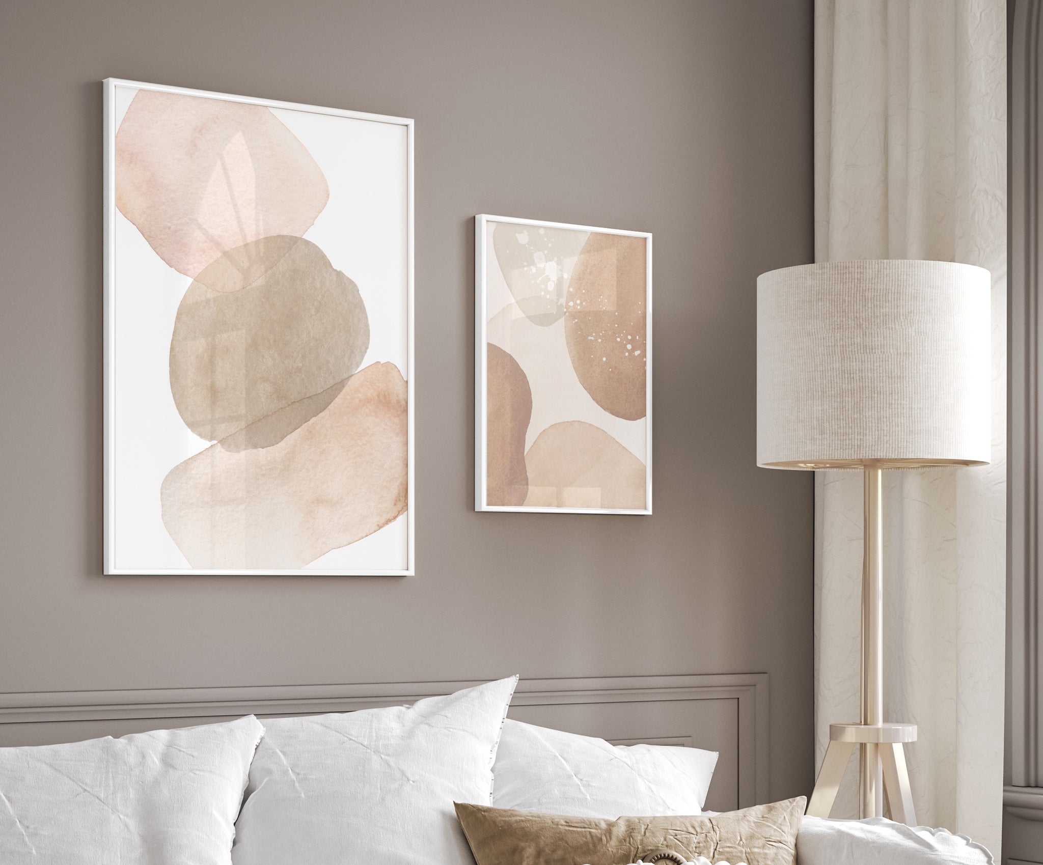 Set of 2, neutral toned abstract wall art in white frames pictured in a neutral cosy living room.