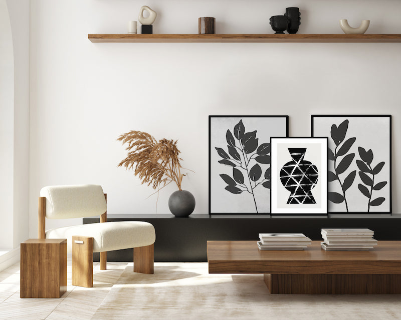 Black and white gallery wall art with black frames in a black, white and wooden living room.