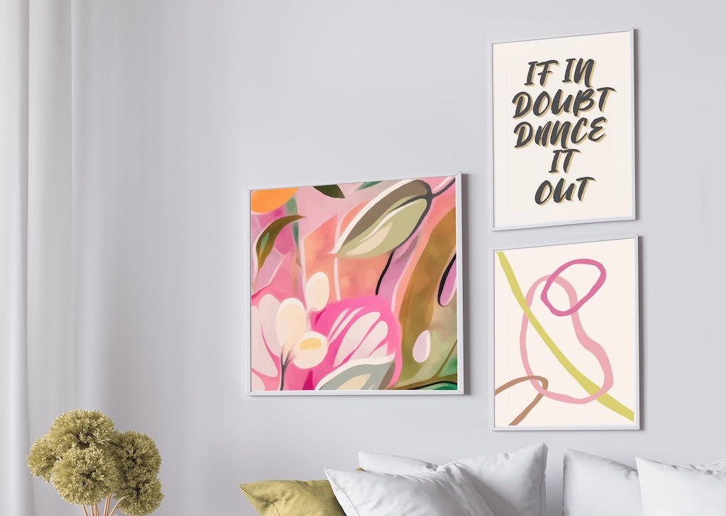 colourful boho abstract wall art gallery wall with pink and green tones in white frames, pictured in a grey and neutral living room.