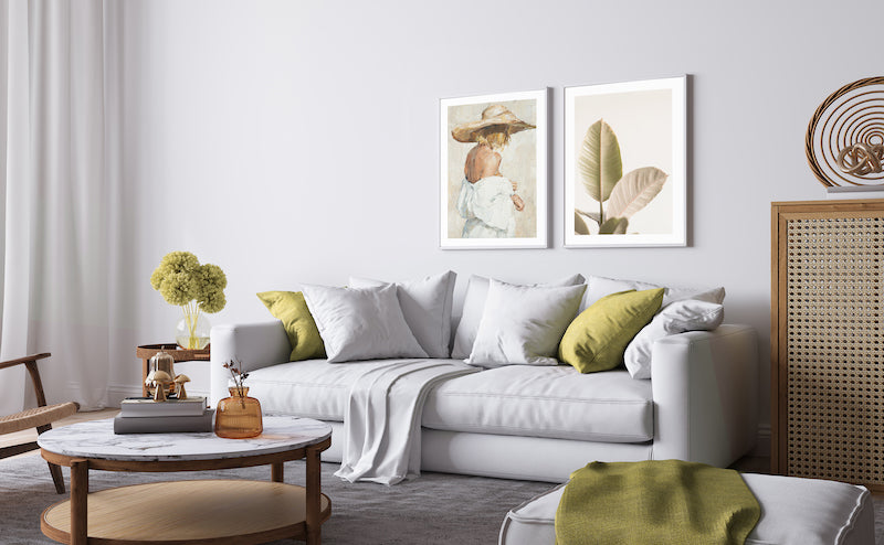Botanical leaf wall art in green hues pictured with a figure painting and in a green and neutral living room.