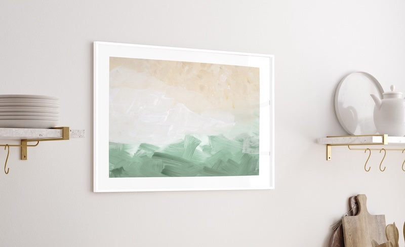 Natural abstract wall art of a beach pictured in a neutral kitchen. 