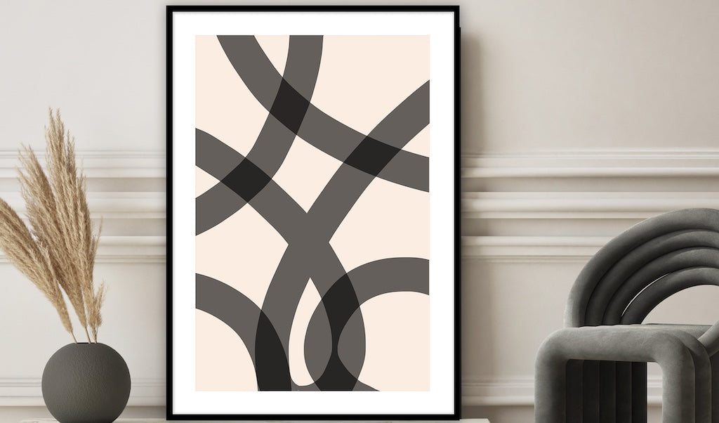 Black and white abstract framed print pictured in a neutral bathroom. 