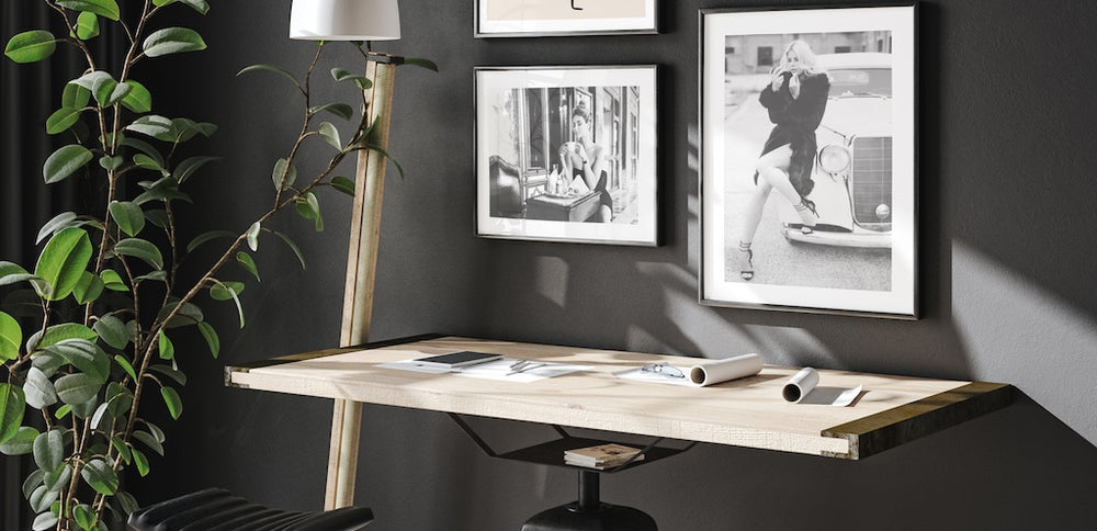 Black and white photography wall art pictured in a home office. 