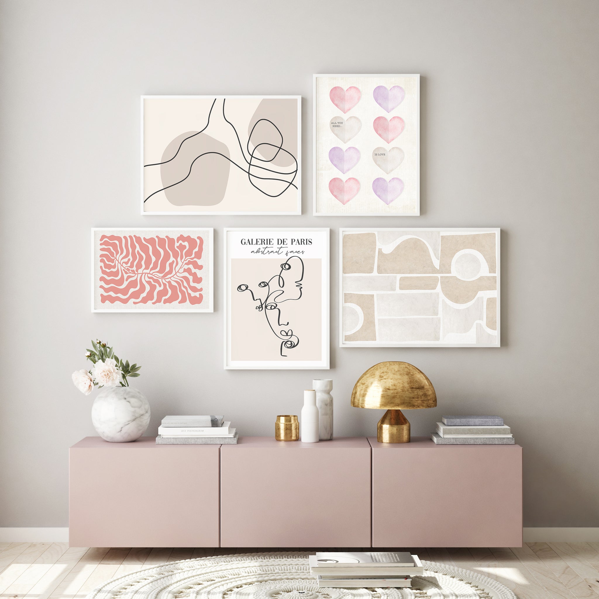 Pink and neutral abstract gallery wall pictured in a neutral and pink bedroom. 
